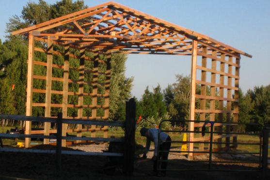 Early Bldg In Process & John with hay