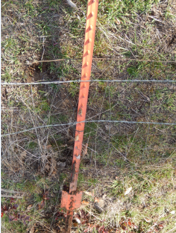 Straight fence post on ground